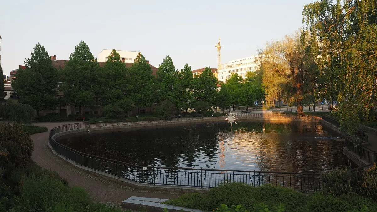 A view of the Tammerinlampi pond at the Tammerinpuisto park in central Tampere, Finland on an evening in June 2025.
