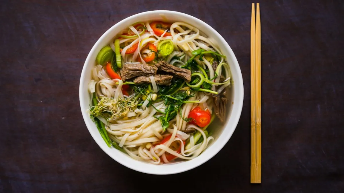 Pho Bo - Vietnamese fresh rice noodle soup with beef, herbs and chili. Vietnam's national dish. Top view
