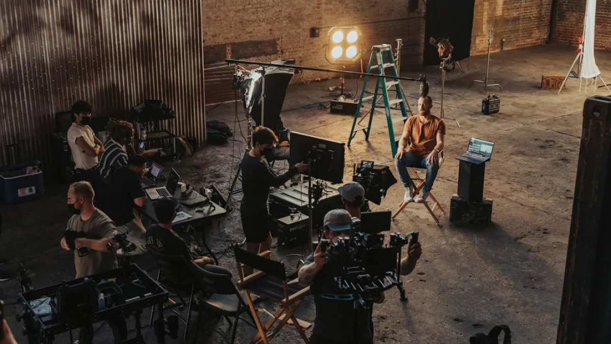 a group of people standing around a camera set up