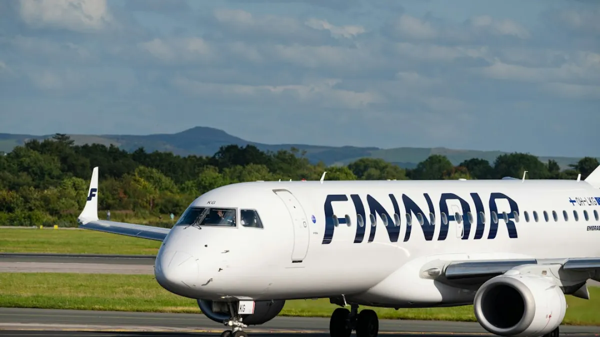 A finnair airplane on a runway at an airport