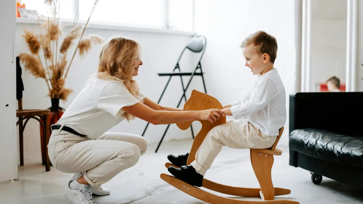 a woman and a child playing on a rocking chair