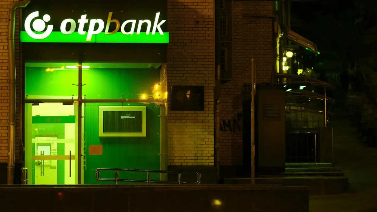 OTP bank branch at night with illuminated sign