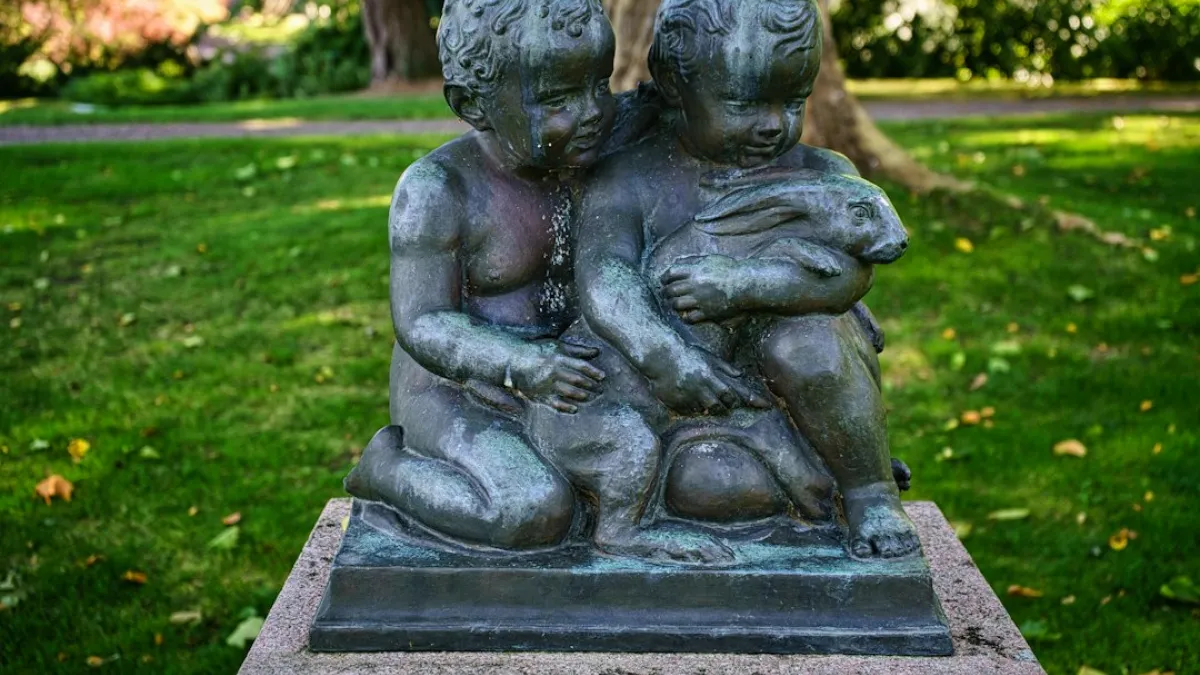 Sculpture of 2 children with a rabbit