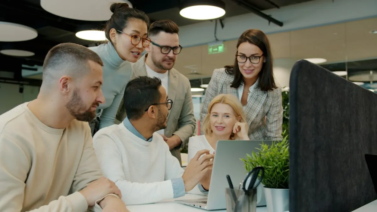 🎬 FULL 4K VIDEO for this still is in my bio link! ⬇️ Creative multi-ethnic team men and women are discussing project looking at laptop screen then clapping hands enjoying success. People and business concept.