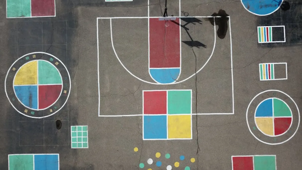 Aerial view of a vibrant, geometric playground with colorful painted designs.