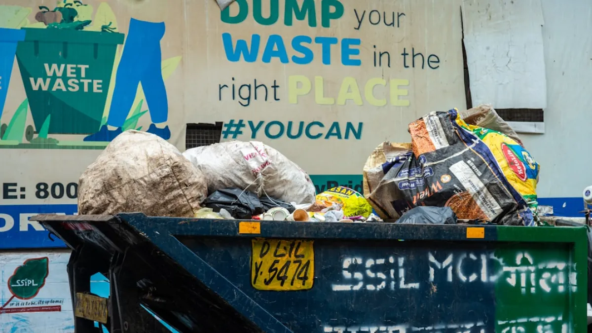 A municipal garbage truck in Delhi, India, filled with bags of dry waste and recyclables.