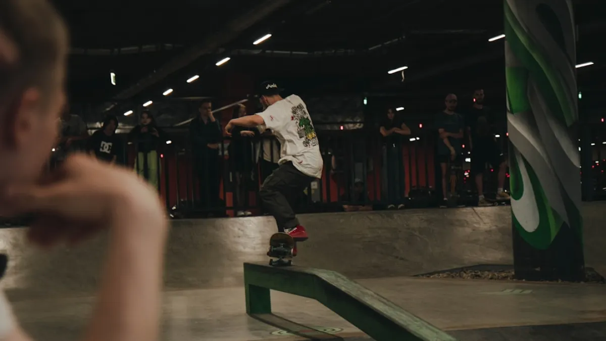 man in white shirt and black pants playing skateboard