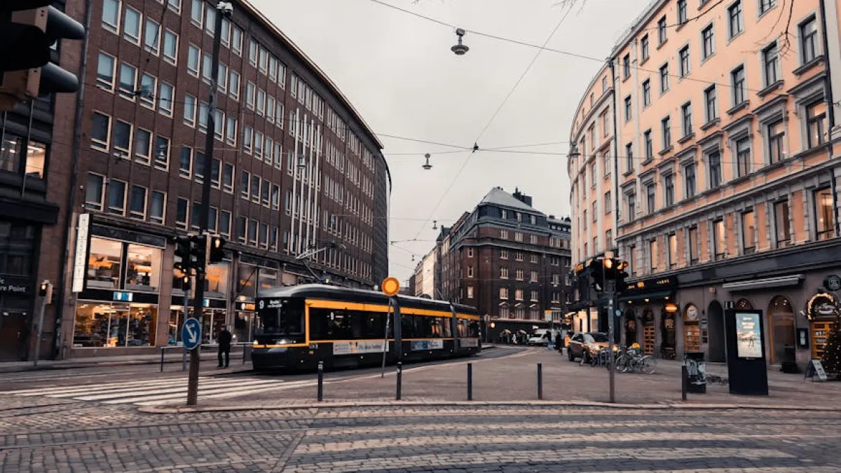Evening street view of a tram in Helsinki, showcasing urban architecture and city life.