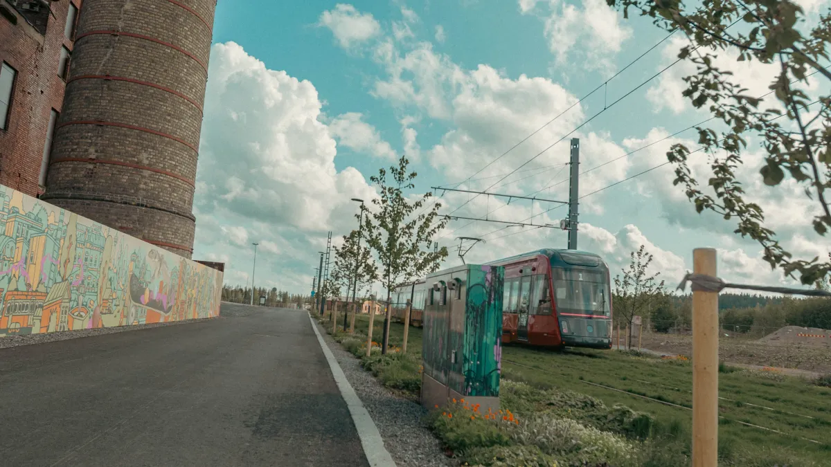 Tampere tram driving amongst urban artwork.
