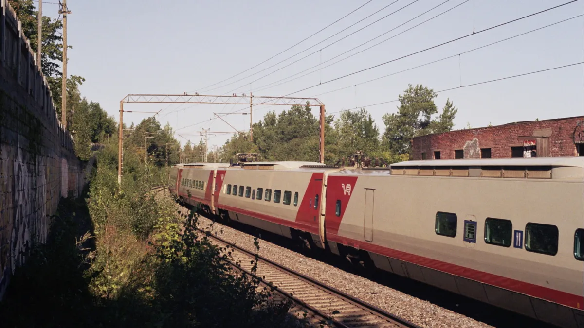 A Pendolino train passing a former roof felt factory in the Santalahti district of Tampere, Finland.